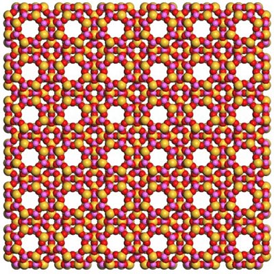 Diagram of a square grid of alternating red, pink, and yellow atoms. There are regularly spaced holes in the grid where there are no atoms.